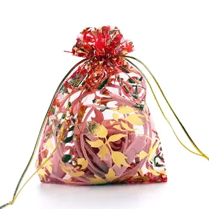 Red organza gift bag with gold rose pattern and drawstring closure for jewelry