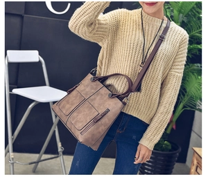 Brown vintage faux leather tote bag with dual front zippers and adjustable shoulder strap