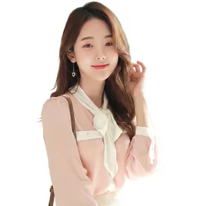 Detailed texture of light pink chiffon shirt with large bow tie and jacquard pattern