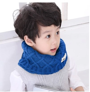 Blue knitted winter scarf for kids featuring a stylish diamond pattern and mustache tag