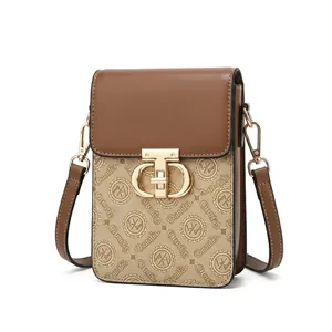 Detail of the golden metal rotary lock and printed texture on a square crossbody bag