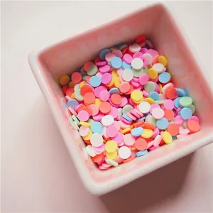 Colorful macaron polymer clay slices for DIY phone case crafts in a pink ceramic bowl