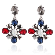 Macro detail of vintage silver earrings with colorful resin gemstones and rhinestones