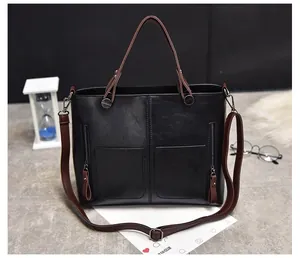 Detail of vintage tote bag with dual front zipper pockets and textured faux leather
