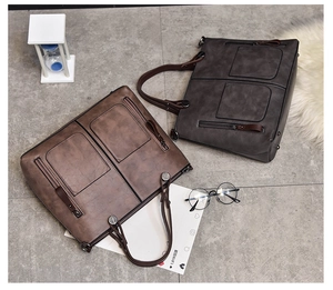 Detailed top view of retro oil leather tote bags in dark brown and charcoal grey colors