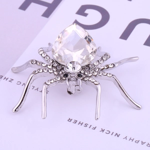Elegant silver-toned spider brooch featuring a large pear-cut crystal and sparkling rhinestones