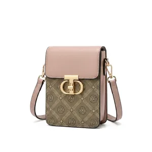 Detail shot of mini crossbody phone bag with vintage pattern and metal clasp closure