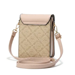 Rear view of mini crossbody phone bag in beige logo canvas and light pink leather trim