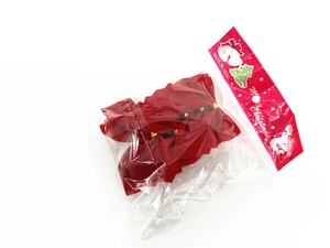 Detail of red velvet Christmas bows with gold twist ties in festive polybag packaging