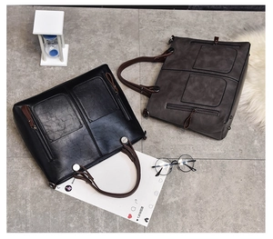 Detail showing vintage faux leather tote bags with contrast straps and side zippers