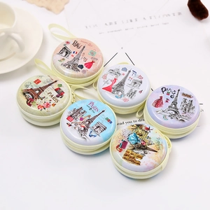 Detail of round tinplate coin purses featuring vintage Paris Eiffel Tower illustrations