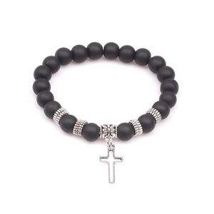 Matte black volcanic stone yoga bracelet with silver floral beads and a hollow cross charm