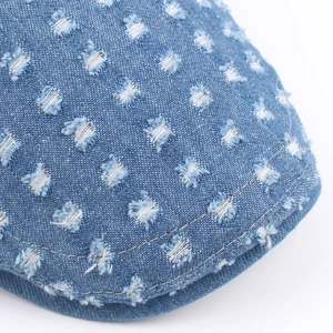 Vintage washed blue denim beret with distressed rip details for women's outdoor style