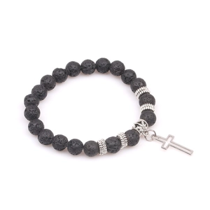 Detailed macro view of black lava stone yoga beads with a silver cross pendant