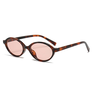 Retro oval tortoiseshell sunglasses with pink lenses shown from a 45-degree angle view