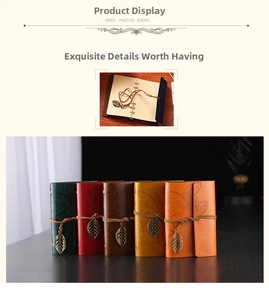 Close-up of vintage leather notebooks in five colors with metal leaf charms and binders