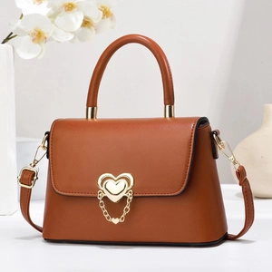 Chic brown leather handbag with gold heart clasp and chain detail for women