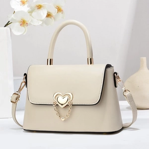 Elegant off-white crossbody bag with heart-shaped gold buckle and chic chain strap