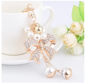 Close-up of bowknot keychain with clear rhinestones and LOVE letter pearl bead
