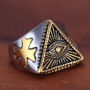 Macro detail of vintage All-Seeing Eye ring with gold triangle and cross relief