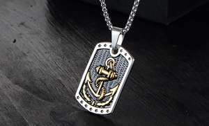 Macro shot of silver military dog tag pendant with golden anchor and box chain