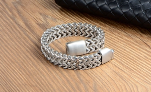 Detail of silver-colored titanium steel woven chain bracelet with matte square magnetic clasp
