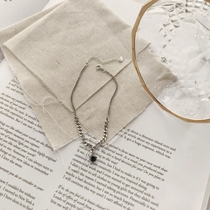 Close-up of retro S925 sterling silver chain anklet with black zircon and heart tag