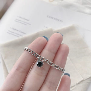 S925 Sterling silver anklet with black zircon stone on chain shown on woman foot