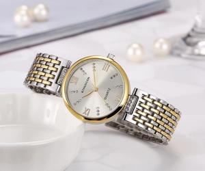 Detailed close-up of crystal-accented quartz watch bezel and Roman numeral markers