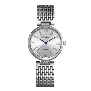 Close-up of silver steel watch dial with Roman numerals and sparkling rhinestones