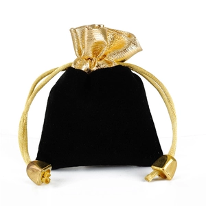 Black velvet drawstring jewelry pouch with golden foil wave edge and gold tassels