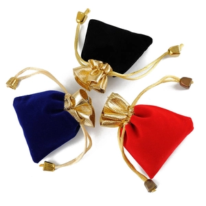 Red blue and black velvet drawstring jewelry pouches with gold trim and metal toggles