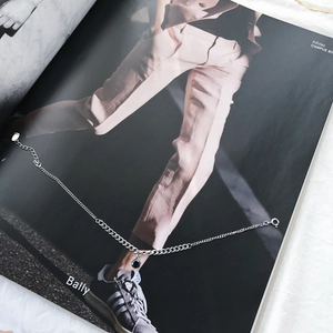 Detailed view of S925 sterling silver chain necklace with black zircon stone on a magazine