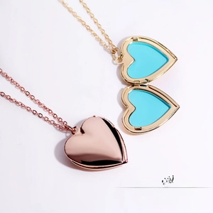Detailed comparison of open and closed heart-shaped floating locket pendants on white background