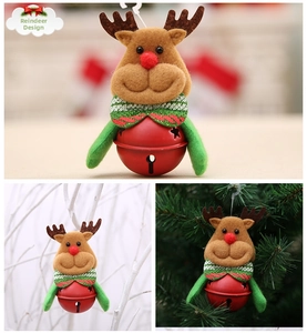 Detail of Christmas reindeer plush with red hollow metal bell hanging on a tree