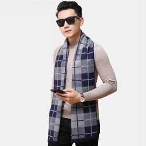 Detail of blue and grey plaid scarf with soft tassels for mature men in winter