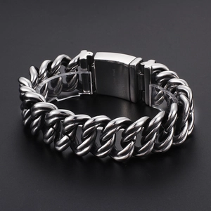 Bold silver stainless steel thick Cuban link chain bracelet with polished clasp on black background