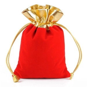 Red velvet drawstring jewelry bag with gold trim and metallic cord for gift packaging