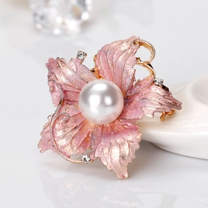 Elegant floral brooch with pink enamel petals, a large pearl center, and gold metal accents