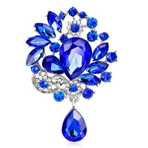 Macro view of vintage silver alloy brooch with blue waterdrop crystal pendants