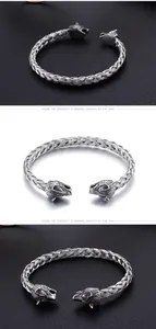 Macro shot of silver woven stainless steel bracelet with vintage wolf head details