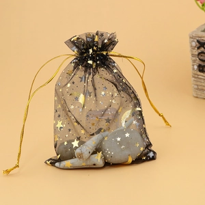 Detail of black organza drawstring bag with gold star and moon foil printing