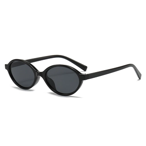 Classic oval small frame sunglasses in all-black minimalist retro chic design for women