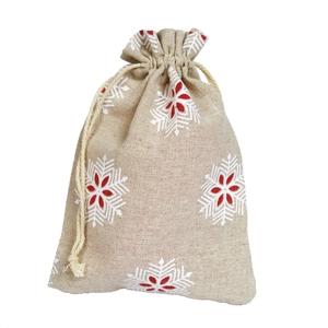Detail of beige linen drawstring pouch featuring a festive red and white snowflake pattern