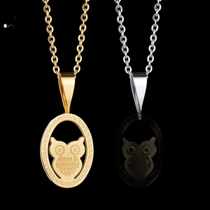 Macro shot of owl pendants in gold and silver finish with Greek fret patterns