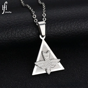 Detailed macro view of a silver stainless steel triangle pendant with bird engraving