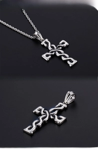 Detailed view of vintage cross pendant with intricate twisted rope design and silver finish