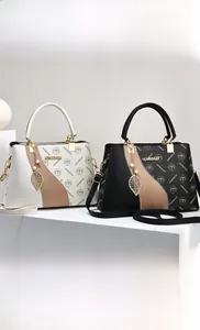 Detail view of stylish PU leather bags with metal leaf pendant and branded textures