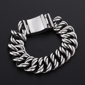Polished silver stainless steel heavy Cuban link bracelet on a sleek black background