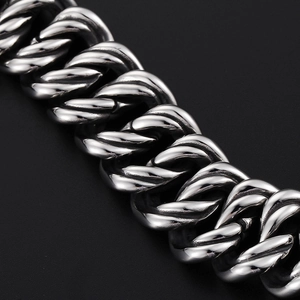 Polished silver stainless steel thick link chain bracelet for men on black background